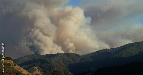 Loma Fire wildfire burning in Santa Cruz Mountains above San Jose with massive billowing smoke plume in late afternoon