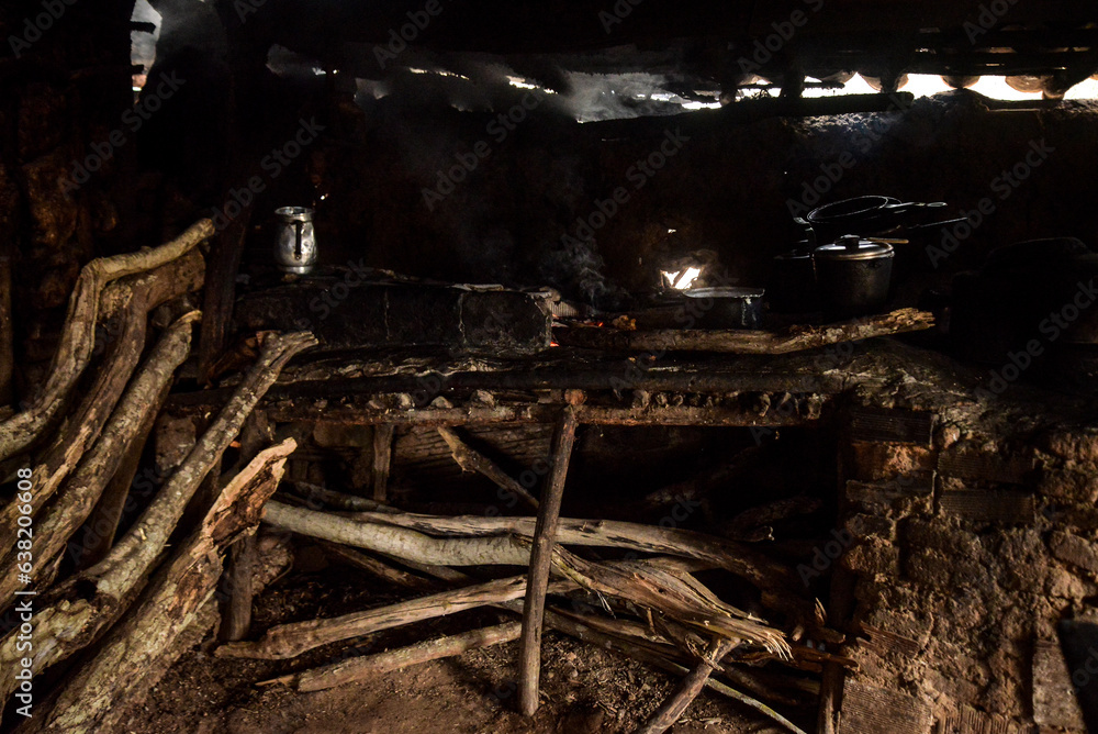firewood in the kitchen, flame from the stove wood stove, wood stove, simple house in the interior of Brazil, mud house, northeastern reality, coal burning, poverty in Brazil firewood in the kitchen, flame from the stove wood stove, wood stove, simple house in the interior of Brazil, mud house, northeastern reality, coal burning, poverty in Brazil