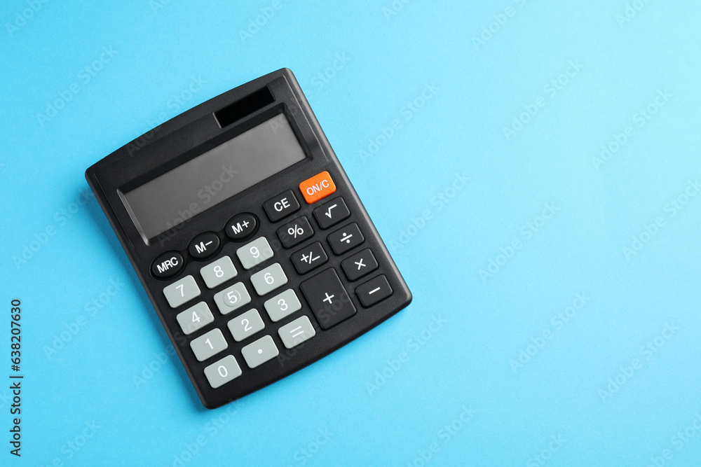 Calculator on light blue background, top view. Space for text Calculator on light blue background, top view. Space for text