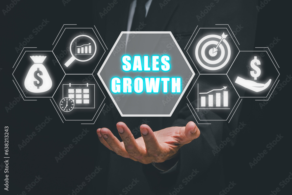 Naklejka premium Sales growth concept, Business person hand holding sales growth icon on virtual screen.