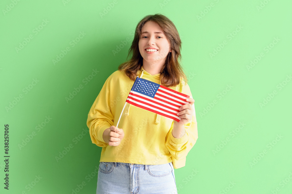 Young woman with USA flag on green background Young woman with USA flag on green background