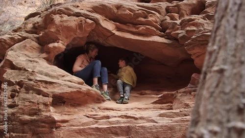 Reveal mother and son in rock crevace cave on exciting exploration adventure