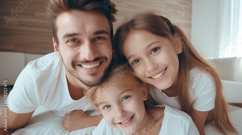 Close-up of three happy individuals wearing contemporary white t-shirts and an adorable kid they are cuddling and leaning on.