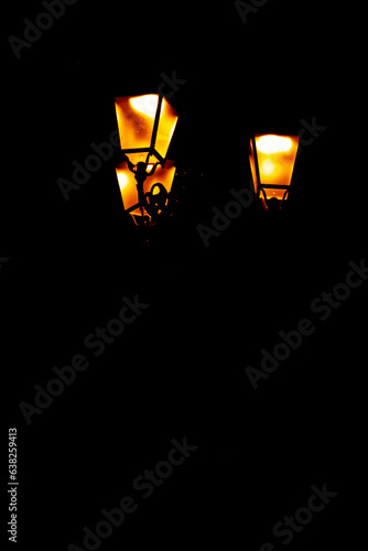 Glowing street lamp in a dark night - vertical