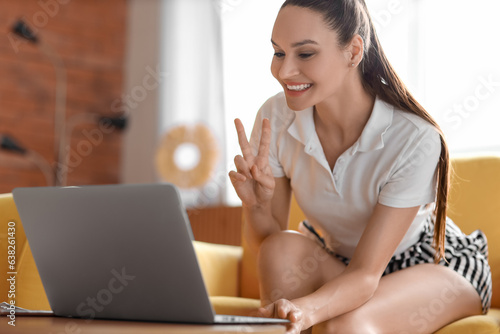 Young woman using laptop on her day off at home