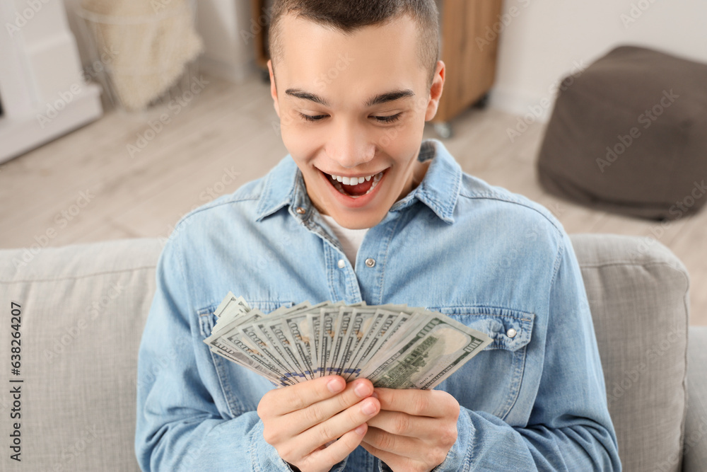 Happy young man with dollar banknotes at home, closeup Happy young man with dollar banknotes at home, closeup