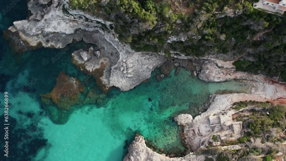 Es Calo des Macs - Small Beach Between Cliffs With Turquoise Water In Balearic Islands, Spain. aerial topdown Es Calo des Macs - Small Beach Between Cliffs With Turquoise Water In Balearic Islands, Spain. aerial topdown