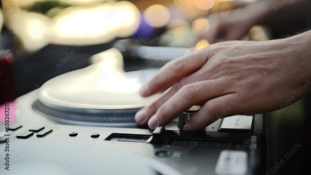 DJ Fast-Forwards Track on Turntable to Mix Music at Outdoor Event Party DJ Fast-Forwards Track on Turntable to Mix Music at Outdoor Event Party