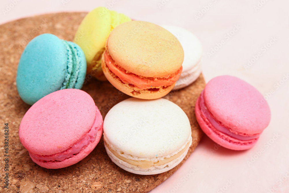 Board with sweet macaroons on pink background Board with sweet macaroons on pink background