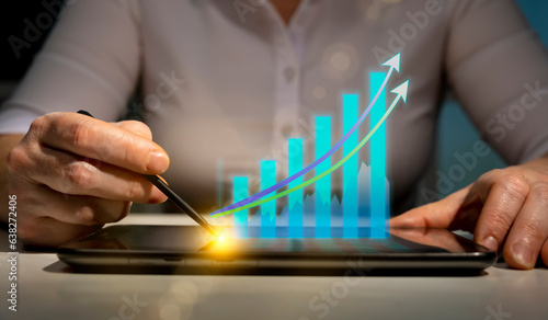 Growth charts with increasing arrows of business development planning, startup success strategy. Woman analyst showing financial graphs using tablet