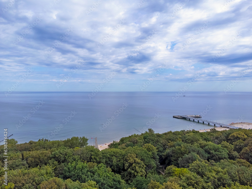 Aerial view landscape, view of forest, horizon, sea and blue sky in Kolobrzeg
