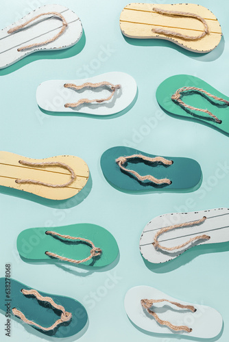 Female summer shoes sandals as creative minimal pattern with hard shadow, blue green yellow flip flops on turquoise gradient color background. Aesthetic trend summer fashion concept, life style