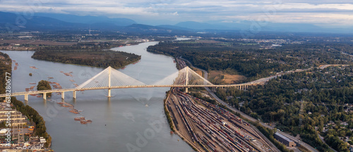 Aerial View of Fraser River and City. Cloudy Sunset Sky. Panorama. Pitt Meadows, Vancouver, BC, Canada © edb3_16