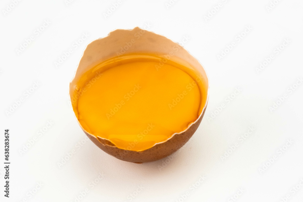 Broken egg in half eggshell isolated on white background. close up of broken egg Broken egg in half eggshell isolated on white background. close up of broken egg