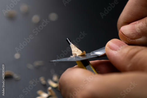 Wallpaper Mural Hands sharpening pencil using utility knife, close up. Torontodigital.ca
