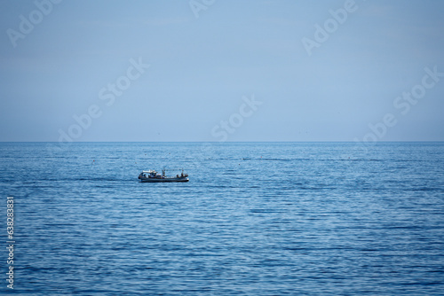 a small boat fishing on the sea © UsefulStone