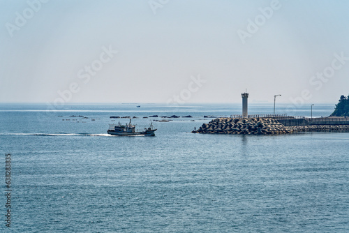 Small boats and lighthouses on the blue sea