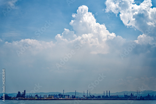 an industrial complex with fine clouds