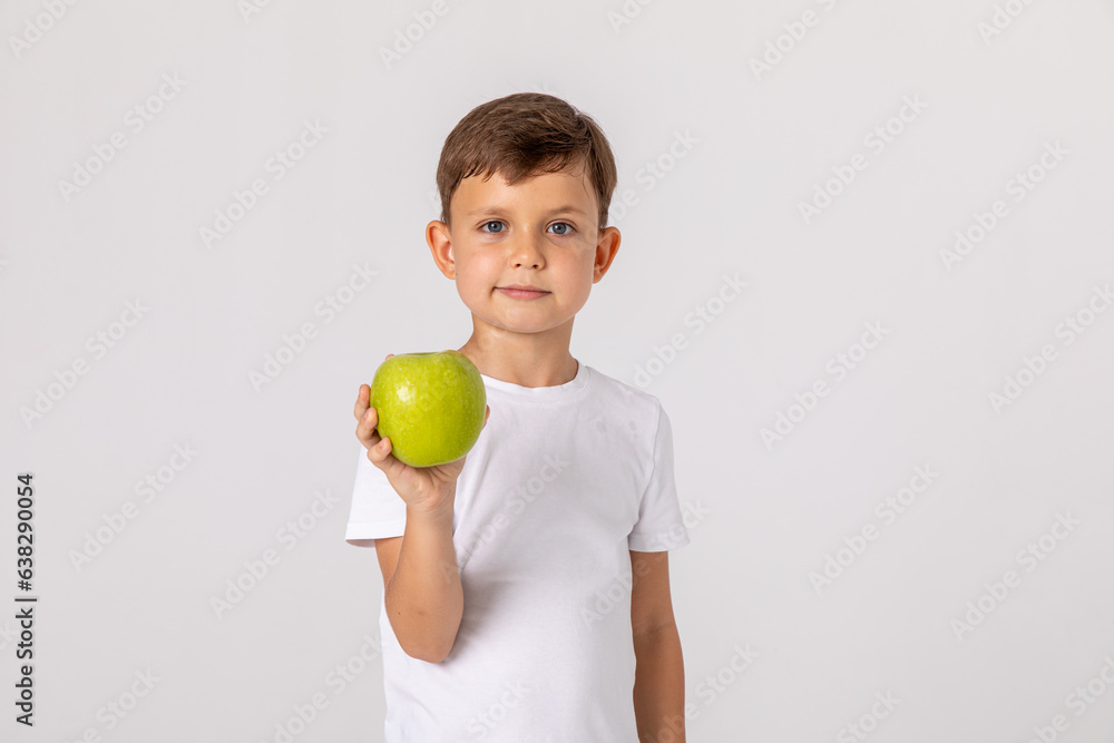 Boy eating apple and smiling. Boy smiles and has healthy white teeth. Little boy eating apple. Boy apples showing. Child with apples. Boy eating apple and smiling. Boy smiles and has healthy white teeth. Little boy eating apple. Boy apples showing. Child with apples.