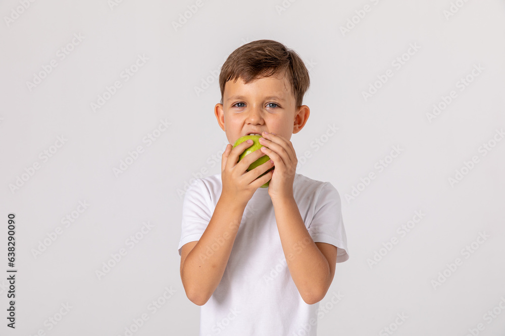 Boy eating apple and smiling. Boy smiles and has healthy white teeth. Little boy eating apple. Boy apples showing. Child with apples. Boy eating apple and smiling. Boy smiles and has healthy white teeth. Little boy eating apple. Boy apples showing. Child with apples.
