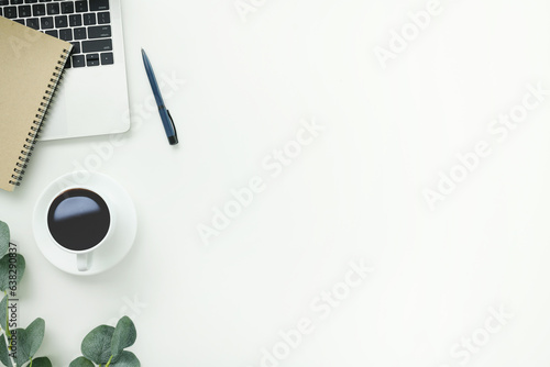 Top view office table desk workspace frame with green leaves eucalyptus, notebook and coffee cup isolated on white background. Flay lay,  ideas, notes or plan writing concept