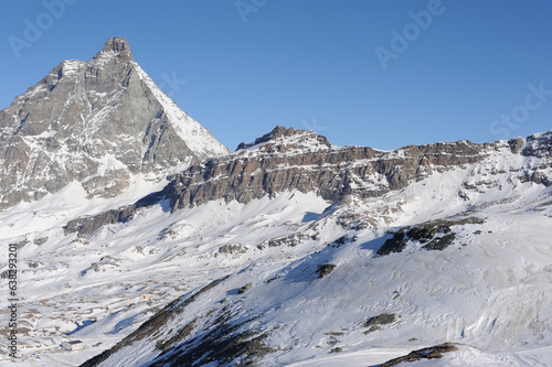 Matterhorn mountain peak in Alps in winter with snow and clear blue sky in Cervinia, Italy and Zermatt, Switzerland. Beautiful and magnificent landscape on a sunny day