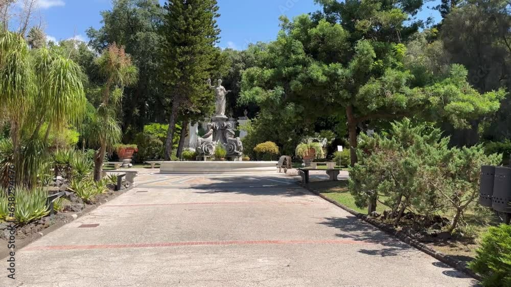 Botanical garden near the Summer Residence (palace) of the Neapolitan Kings in the city of Portici, Italy. A quiet place, summer coolness from tall trees, a city park Botanical garden near the Summer Residence (palace) of the Neapolitan Kings in the city of Portici, Italy. A quiet place, summer coolness from tall trees, a city park