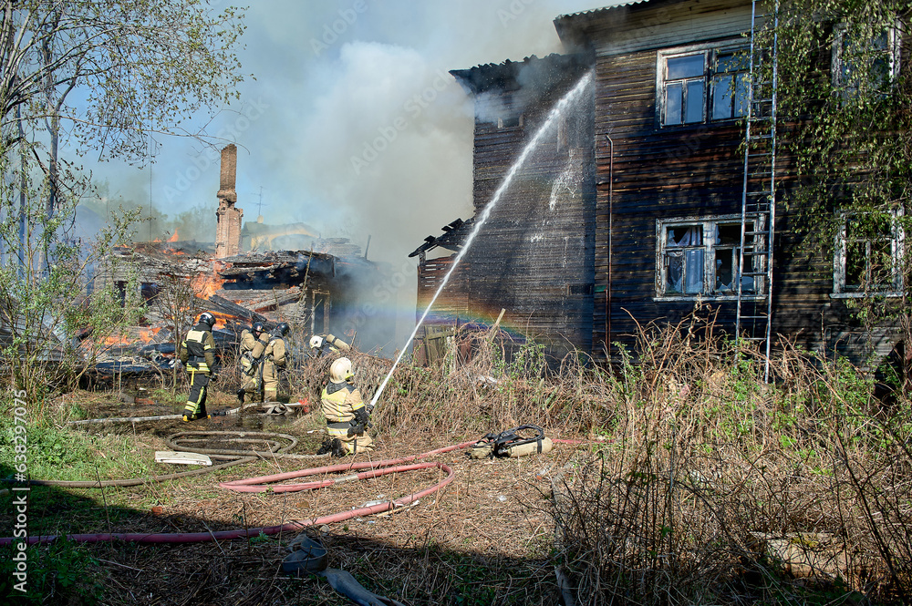Obraz premium extinguishing the fire of a wooden house