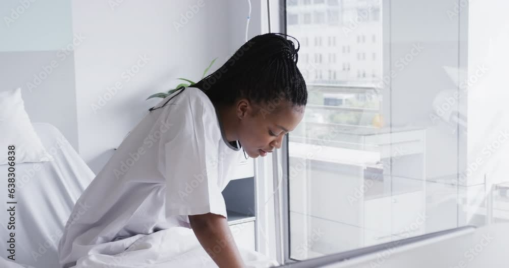 African american female patient in bed in hospital room, slow motion African american female patient in bed in hospital room, slow motion