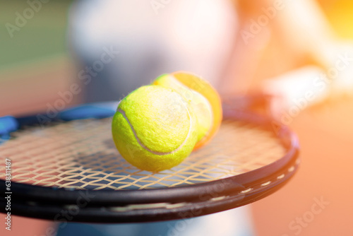 Tennis balls and rocket on court field in sunny day © Ivan Zelenin
