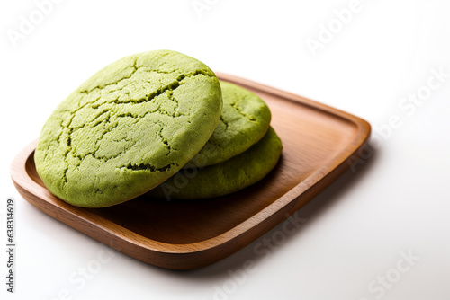 Wallpaper Mural three green tea "matcha" cookies on a wooden plate isolated on white background Torontodigital.ca