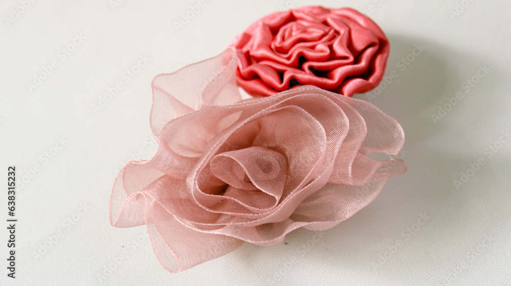  pink rose-shaped brooch made of cloth - obrazy, fototapety, plakaty 