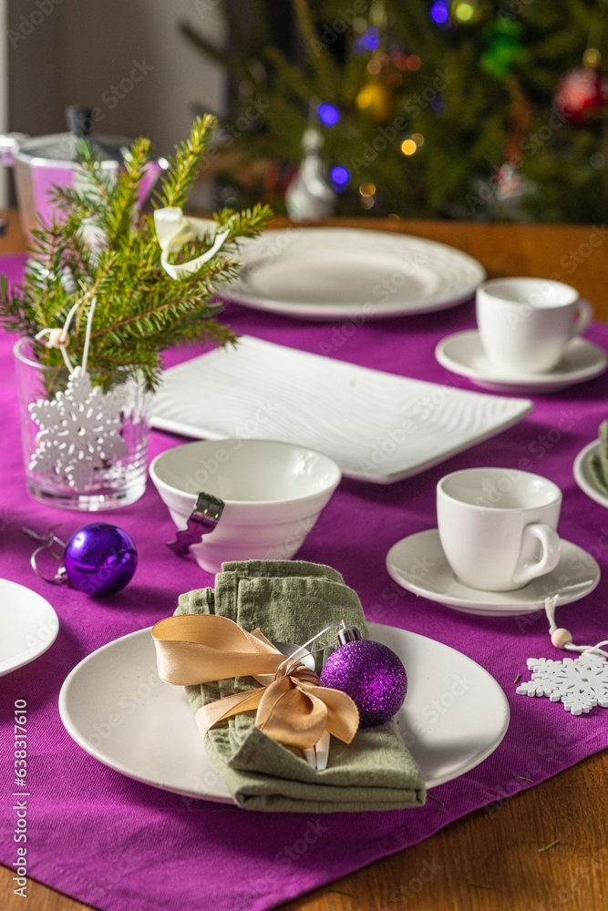 Coffee table setting with white tableware in Christmas style on a table with a purple tablecloth. Merry Christmas concept. Receiving guests, Coffee table setting with white tableware in Christmas style on a table with a purple tablecloth. Merry Christmas concept. Receiving guests,