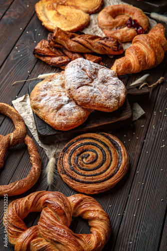 Wallpaper from different types of pastries on brown boards. For decoration of bakery sales outlets. Bakery products. Fresh bakery.