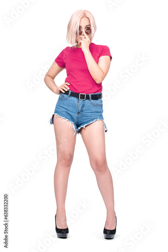 A young pretty Asian girl in a pink T-shirt, denim shorts holds sunglasses on her face with her finger, isolated on a transparent background png. © afxhome