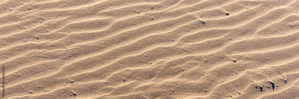 Panoramic image. Wavy sandy background. Beach sand texture Panoramic image. Wavy sandy background. Beach sand texture