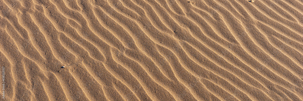 Panoramic image. Wavy sandy background. Beach sand texture Panoramic image. Wavy sandy background. Beach sand texture
