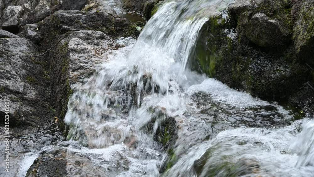 Clear stream running through stone boulders in Sweden. Abundant river flowing on large stones. Wild mountain river water splashing in summer day. Clear stream running through stone boulders in Sweden. Abundant river flowing on large stones. Wild mountain river water splashing in summer day.