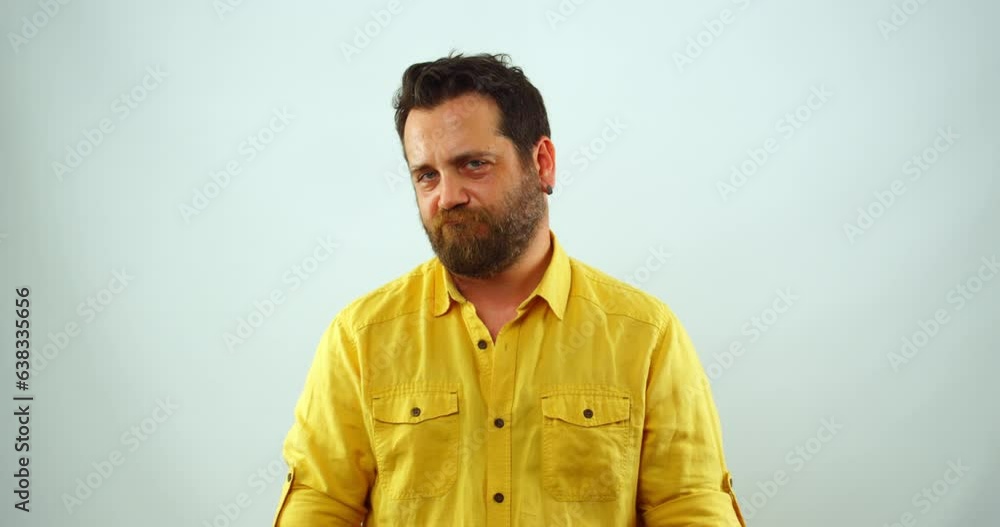A middle-aged man is looking at the camera with a funny facial expression. He shrugs his shoulders, as if to say, A middle-aged man is looking at the camera with a funny facial expression. He shrugs his shoulders, as if to say,