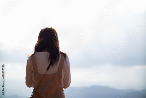 Back scene of woman alone with feeling lonely and depressed on blurred background of beautiful nature scenery . concept of woman who had to be alone in past was depressed when she encountered problems