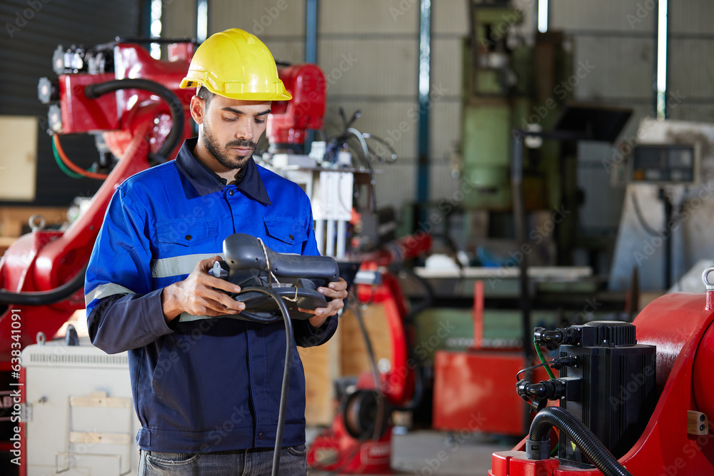 factory worker or engineer operating remote switch controller to control robot machine in the factory factory worker or engineer operating remote switch controller to control robot machine in the factory