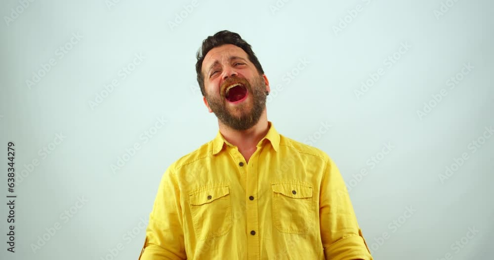 A middle-aged man is in a studio, looking at the camera and laughing. His mouth is wide open, and he appears to be having a hilarious laughing fit A middle-aged man is in a studio, looking at the camera and laughing. His mouth is wide open, and he appears to be having a hilarious laughing fit