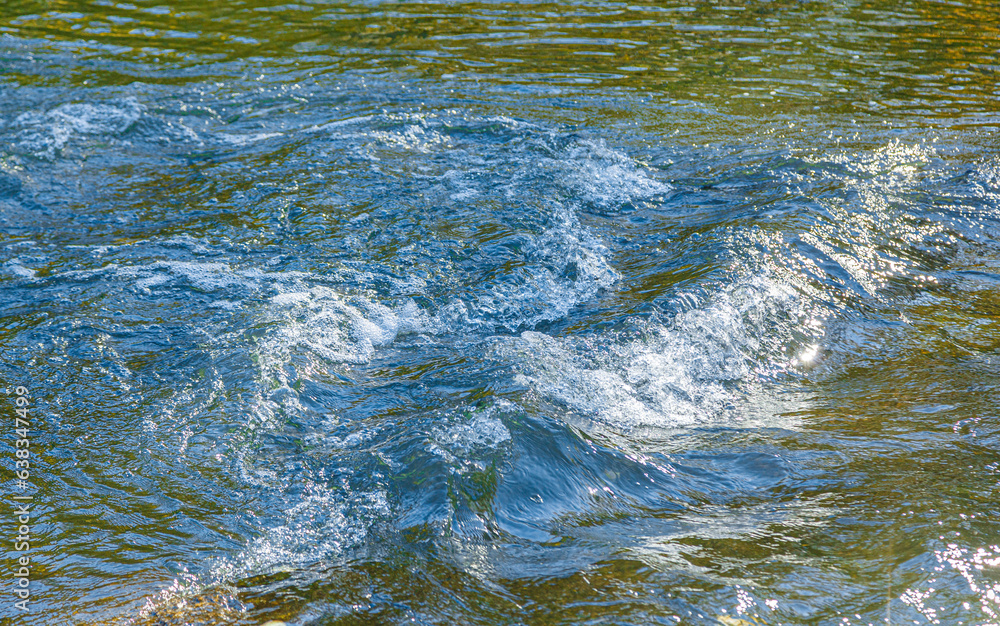 Fototapeta premium flow of water and spray from a stone