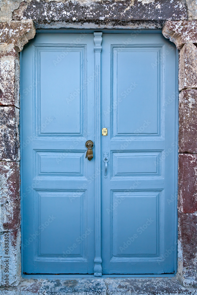 Beautiful light blue, wooden door of an old mansion at the traditional village of Pyrgos Kallistis, in Santorini island, Cyclades, Greece, Europe.