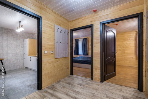 Wallpaper Mural empty corridor in interior of entrance hall with many doors in wooden eco house or homestead Torontodigital.ca