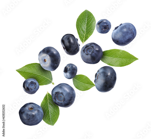 Many ripe blueberries and green leaves falling on white background