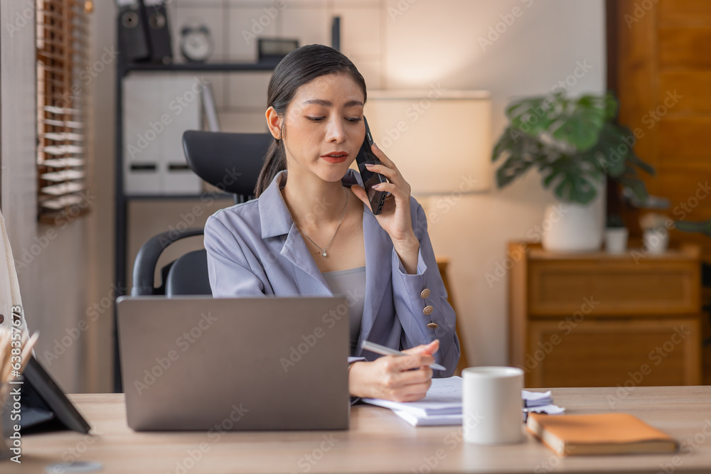 Financial Businesswomen analyze the graph of the company's performance to create profits and growth, Call phone for Market research reports and income statistics, Financial and Accounting concept. Financial Businesswomen analyze the graph of the company's performance to create profits and growth, Call phone for Market research reports and income statistics, Financial and Accounting concept.