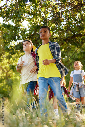 Kids, active children walking in park, forest on warm summer day. Active weekends. Travelers. Concept of leisure activity, childhood, summer, friendship, active lifestyle, fun, nature