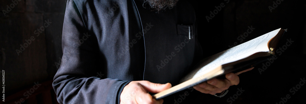 Bible in the hands of the priest