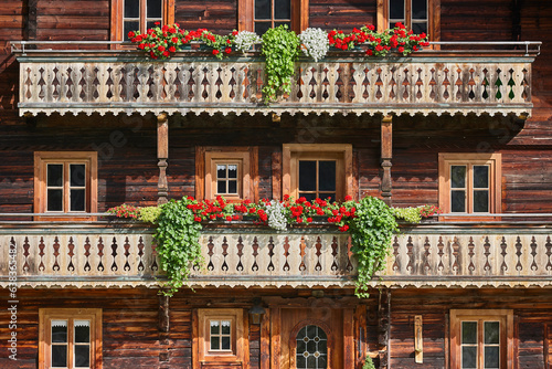 Picturesque rustic wooden house decorated with flowers in Austria